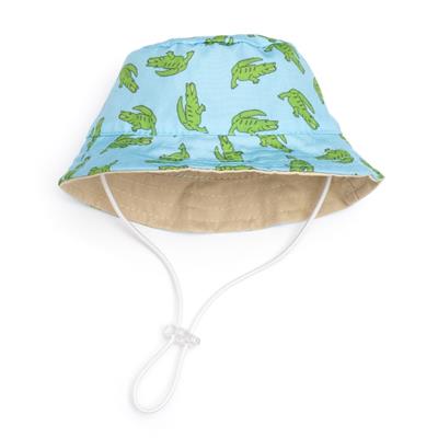 A blue bucket hat with a pattern of alligators illustrations and a beige interior, equipped with an adjustable chin strap.