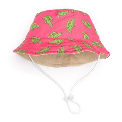 A pink bucket hat with a pattern of alligators illustrations and a beige interior, equipped with an adjustable chin strap.