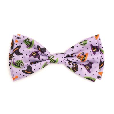 Halloween-themed bow tie with witch hats on a light purple background