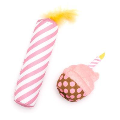 Pink and white striped toy with a polka dot ball on a white background