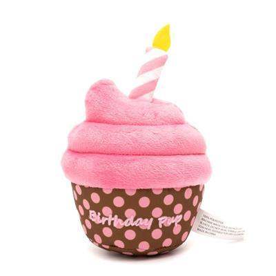 Pink dog cupcake toy with candle with brown base and pink polka dots.