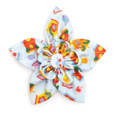 Colorful flower-shaped hair bow with a cartoon character design on a white background
