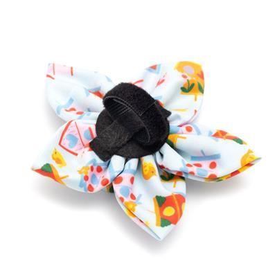 Colorful floral-patterned hair bow with a black center on a white background