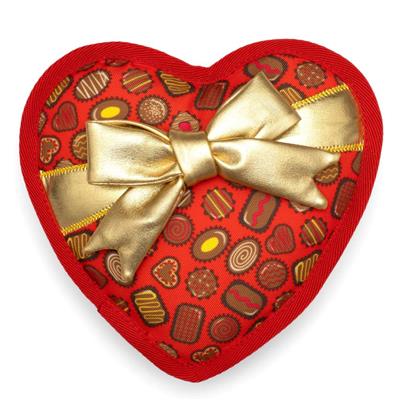 Heart-shaped chocolate box with a gold bow on a white background