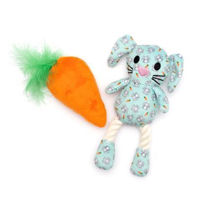 Plush toy rabbit with a carrot and rope on a white background