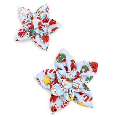 Two colorful fabric collar bows with Christmas-themed designs on a white background.