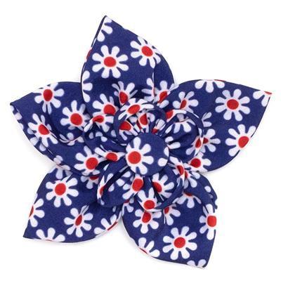 Floral collar bow with red centers on a white background