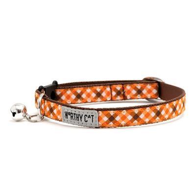 Cat collar with orange plaid pattern and brown accents with bell and label showing "Worthy Cat" on a white background