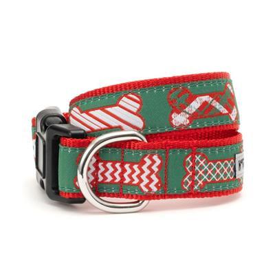 Green dog collar with red, white and green bones on white background.