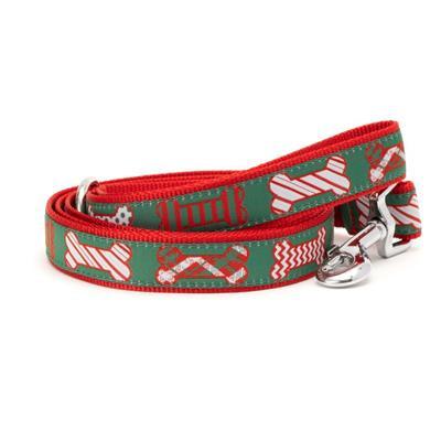 Green dog leash with red, white and green bones on white background.