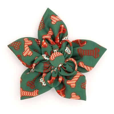 Dog collar flower accessorywith red & green bones on white background.
