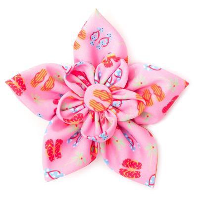 Pink flower-shaped collar bow with colorful patterns on a white background