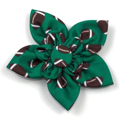 Green dog collar flower with football pattern on a white background