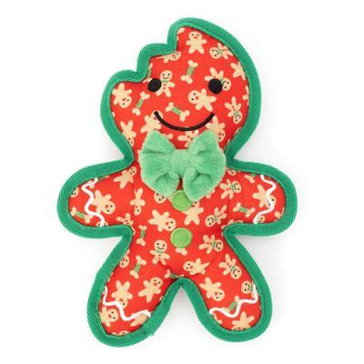 Red gingerbread man dog toy with patterns of gingerbread men and green trim and green bow tie on white background