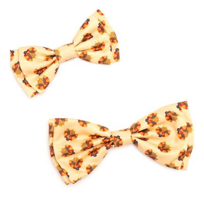 Two yellow bow ties with turkey pattern on a white background