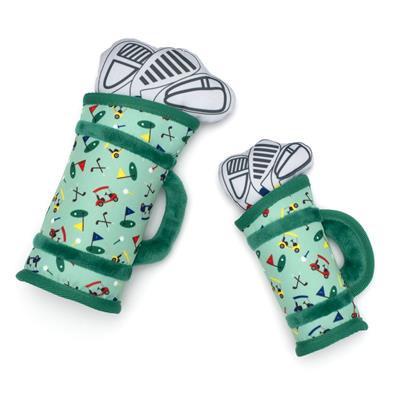 Two green golf bag dog toys with golf-themed designs on a white background