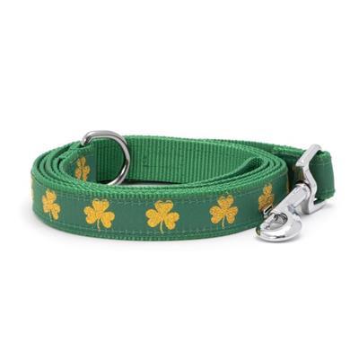 Green dog leash with gold shamrock patterns on a white background