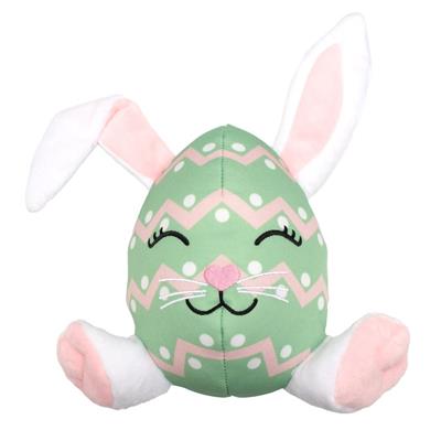 Plush toy shaped like a green egg with bunny ears and face on a white background