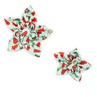 Two decorative bows with a Christmas tree and berry pattern on a white background