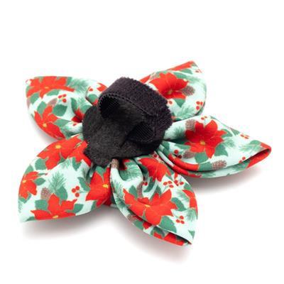Red & green dog collar flower with poinsettia pattern and black Velcro attachment on white background.