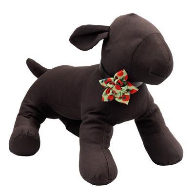 Dog mannequin wearing green bow featuring red tomatoes on white background
