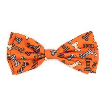 Orange dog bow tie with various patterns of bones on white background