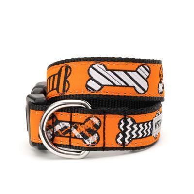 Dog collar with orange and black bones pattern on a white background