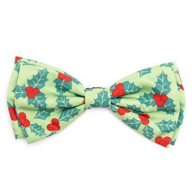 Green bow tie with red berries and blue leaves on a white background