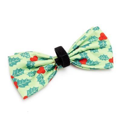 Green bow tie with red berries and green leaves on a white background