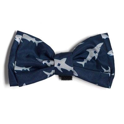 Navy blue bow tie with white shark pattern on a white background