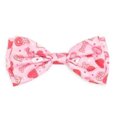Pink bow tie with heart and candy pattern on a white background