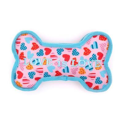 Bone-shaped toy with heart patterns and 'LOVE is LOVE' text on a pink background