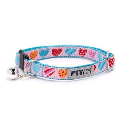 Cat collar with colorful heart pattern and 'Worthy Cat' tag on a white background