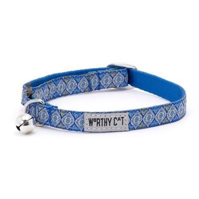 Blue patterned cat collar with a bell on a white background