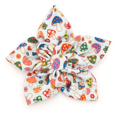 Colorful mushroom-patterned bow on a white background