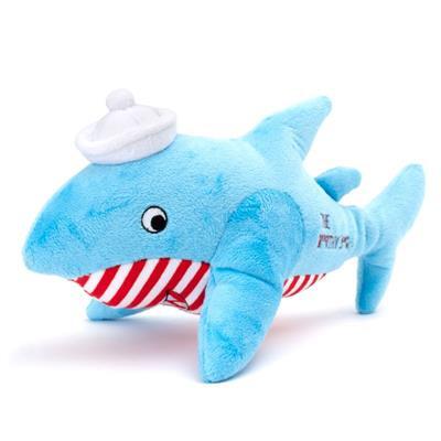 Blue plush shark toy with a white hat and red and white striped shirt on a white background