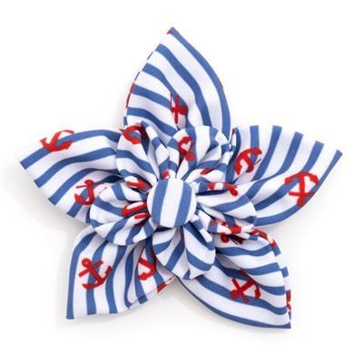 Blue and white striped bow with red anchor patterns on a white background