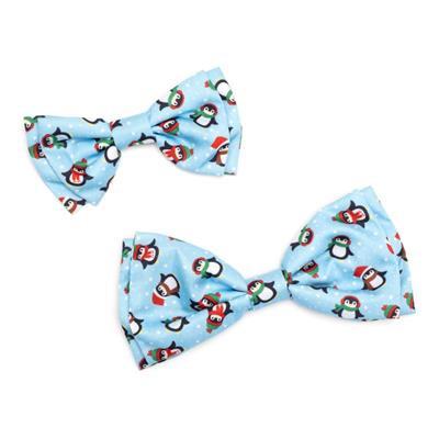 Two blue bow ties with penguin pattern on a white background
