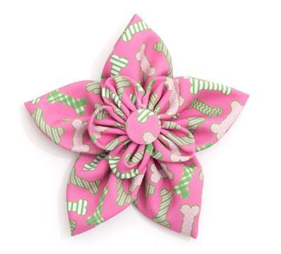 Pink and green floral collar bow with bone pattern on a white background