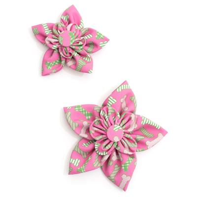 Two pink and green floral collar bows on a white background