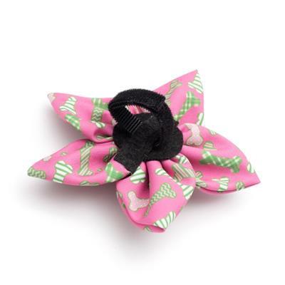Pink and green patterned collar bow with a black center on a white background