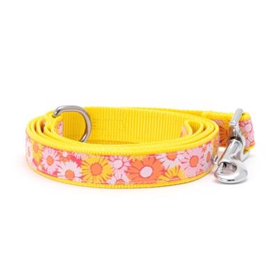 Yellow dog leash with floral pattern on a white background