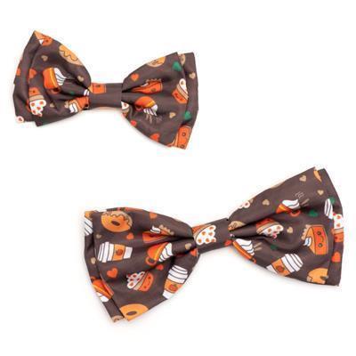 Two brown dog bow ties with patterns of coffee, pumpkin pie and fall on white background