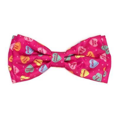 Pink bow tie with colorful heart patterns on a white background