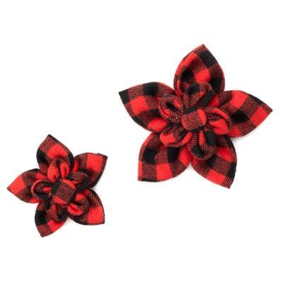 Two red and black plaid flower-shaped collar bows on a white background