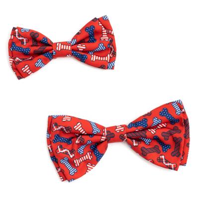 Two red bow ties with blue and white bone patterns on a white background