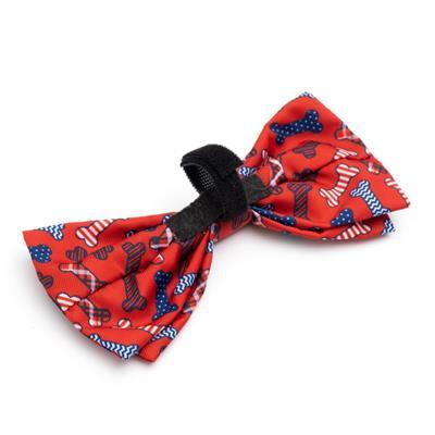 Red bow tie featuring blue & white bones with black Velcro closure on a white background