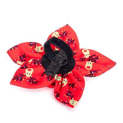 Red flower-shaped collar bow with black center on a white background