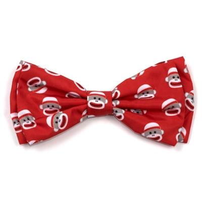 Red bow tie with sock monkey pattern on a white background