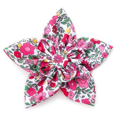 Floral dog collar accessory with pink and green flowers on a white background